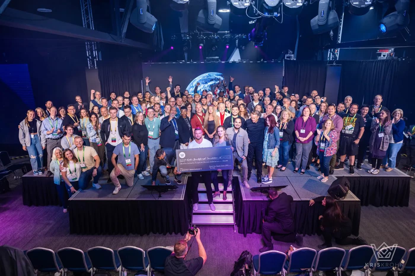 A full auditorium of attendees on stage at a past Unblinded event